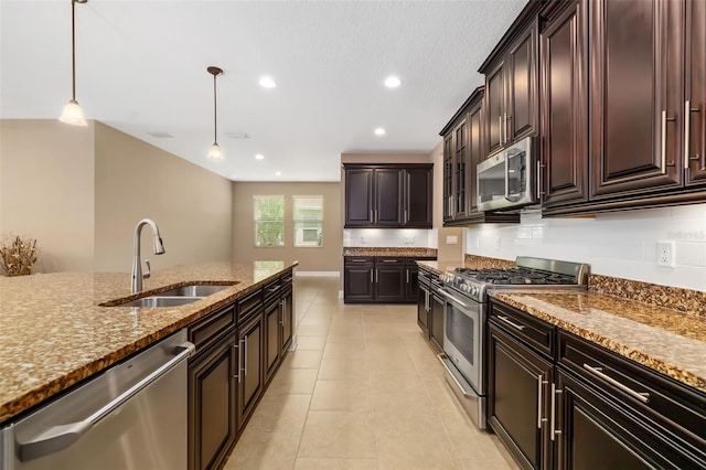 773 Rosemary Cir, Bradenton, FL 34212 - kitchen with appliances with stainless steel finishes, stone counters, pendant lighting, light tile patterned floors, and recessed lighting