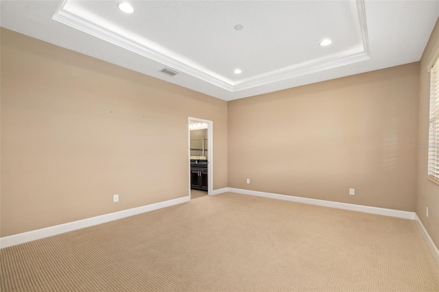 773 Rosemary Cir, Bradenton, FL 34212 - empty room with a tray ceiling, recessed lighting, light colored carpet, and ornamental molding