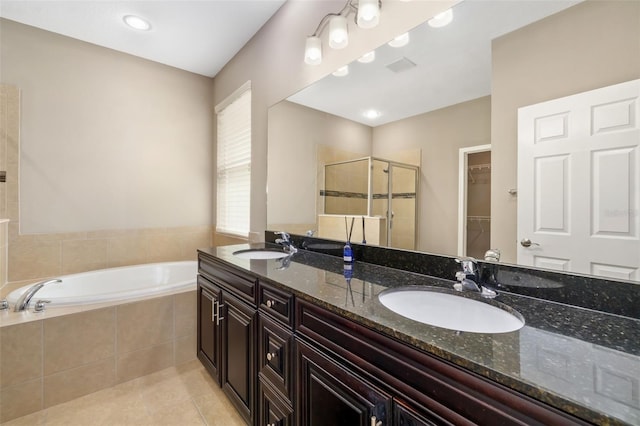 773 Rosemary Cir, Bradenton, FL 34212 - full bathroom with a stall shower, double vanity, tile patterned floors, a garden tub, and a spacious closet