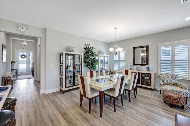 6219 Golden Nettle Dr, Apollo Beach, FL 33572 - dining room featuring a chandelier and light wood-style floors