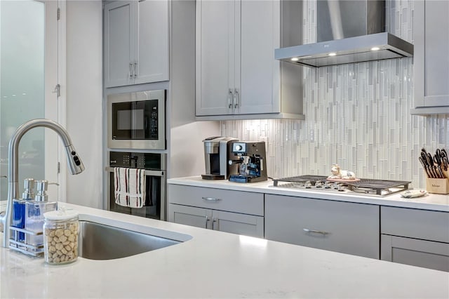6219 Golden Nettle Dr, Apollo Beach, FL 33572 - kitchen with wall chimney exhaust hood, gray cabinets, stainless steel appliances, and light countertops
