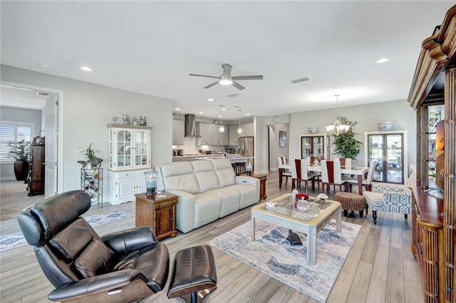 6219 Golden Nettle Dr, Apollo Beach, FL 33572 - living room with ceiling fan, light wood-type flooring, a chandelier, and recessed lighting