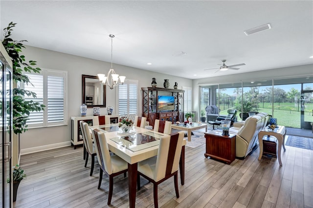 6219 Golden Nettle Dr, Apollo Beach, FL 33572 - dining room with light wood-style flooring, a chandelier, a ceiling fan, and recessed lighting