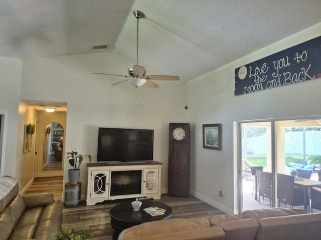 15917 Mercott Ct, Clermont, FL 34714 - living room featuring high vaulted ceiling, a textured ceiling, wood finished floors, and ceiling fan