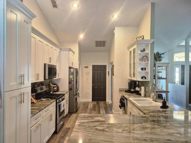 15917 Mercott Ct, Clermont, FL 34714 - kitchen with stainless steel appliances, open shelves, white cabinets, and recessed lighting