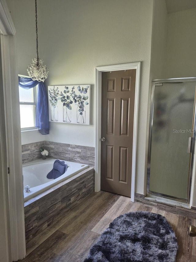 15917 Mercott Ct, Clermont, FL 34714 - full bathroom featuring a shower stall, a bath, a chandelier, and wood finished floors