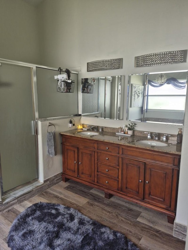 15917 Mercott Ct, Clermont, FL 34714 - full bath featuring a shower stall, wood finished floors, and double vanity