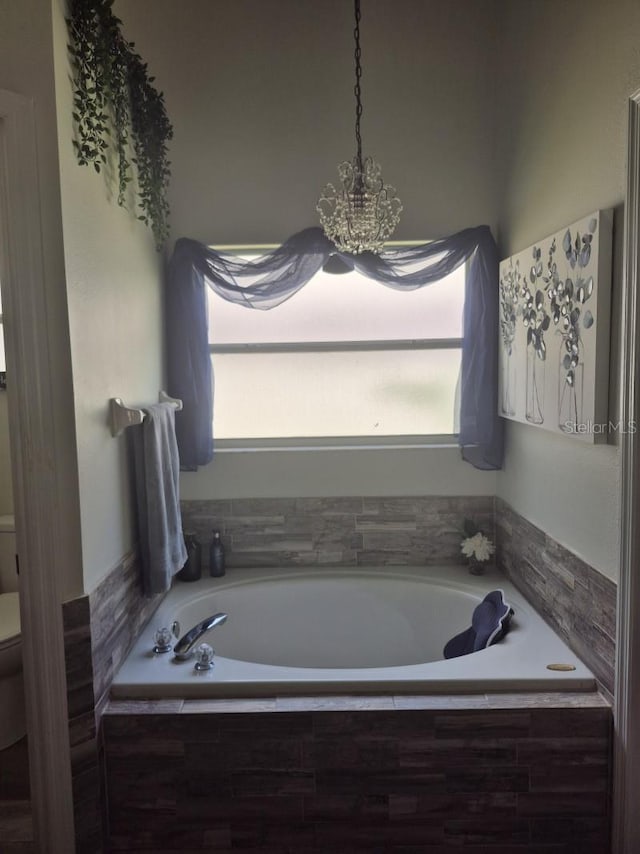 15917 Mercott Ct, Clermont, FL 34714 - full bathroom with a garden tub and a chandelier
