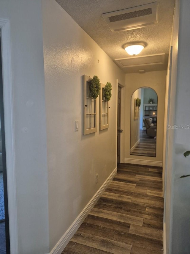 15917 Mercott Ct, Clermont, FL 34714 - hallway featuring a textured ceiling and dark wood finished floors