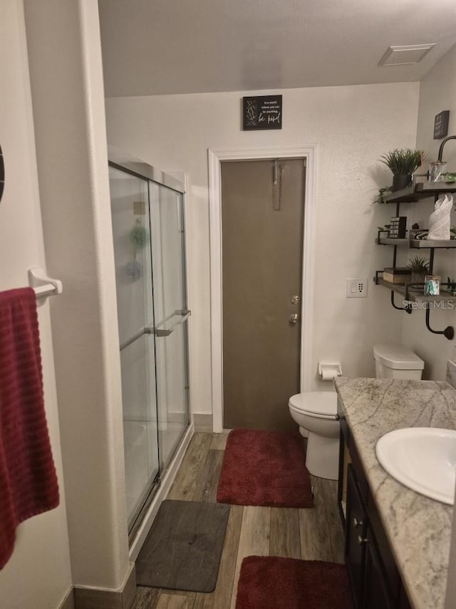 15917 Mercott Ct, Clermont, FL 34714 - bathroom with wood finished floors, a stall shower, and vanity