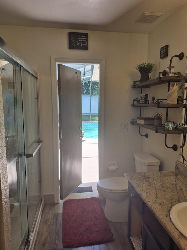 15917 Mercott Ct, Clermont, FL 34714 - bathroom featuring vanity, wood finished floors, and a stall shower