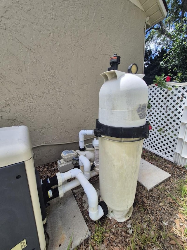 15917 Mercott Ct, Clermont, FL 34714 - exterior view of stucco siding and pump