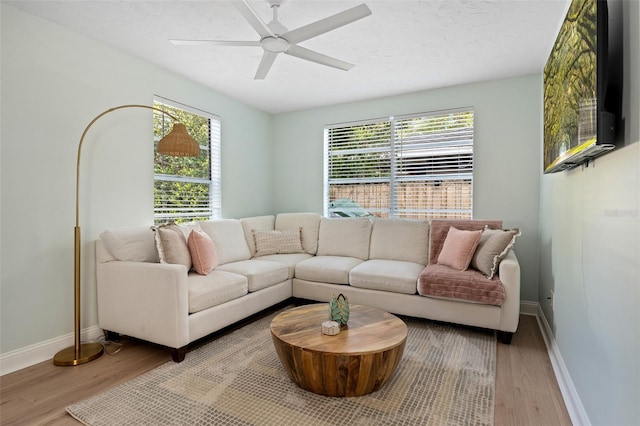 522 31st St W, Bradenton, FL 34205 - living room featuring wood finished floors, healthy amount of natural light, and a ceiling fan
