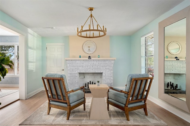 522 31st St W, Bradenton, FL 34205 - living area with a brick fireplace, wood finished floors, and a chandelier