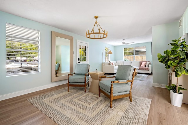 522 31st St W, Bradenton, FL 34205 - sitting room featuring light wood-style flooring, a chandelier, and ceiling fan