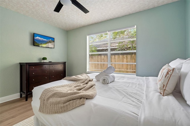 522 31st St W, Bradenton, FL 34205 - bedroom with wood finished floors, a textured ceiling, and a ceiling fan