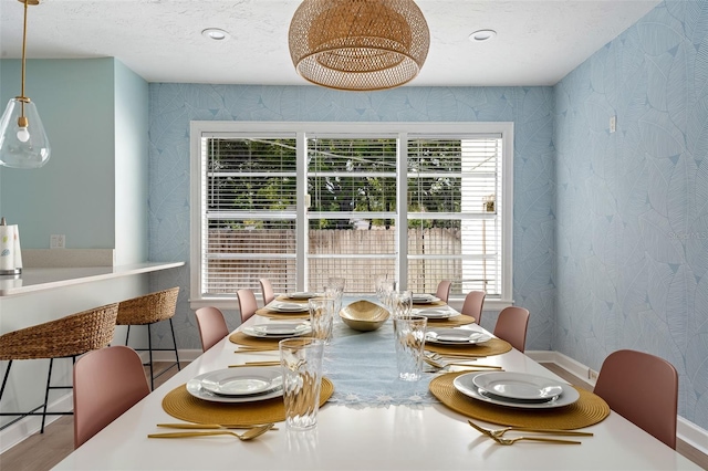 522 31st St W, Bradenton, FL 34205 - dining area featuring wallpapered walls, plenty of natural light, and a textured ceiling