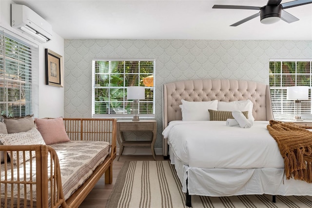 522 31st St W, Bradenton, FL 34205 - bedroom featuring wallpapered walls, wood finished floors, a wall unit AC, and ceiling fan