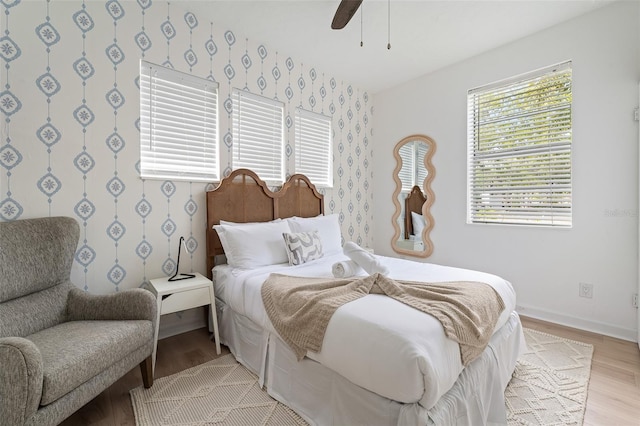 522 31st St W, Bradenton, FL 34205 - bedroom with wallpapered walls, light wood-style flooring, and ceiling fan