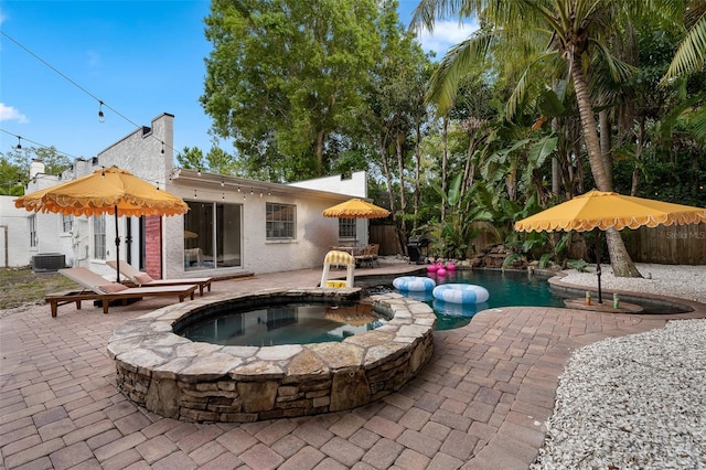 522 31st St W, Bradenton, FL 34205 - view of swimming pool with a patio area, a fenced backyard, and a pool with connected hot tub