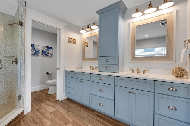 538 Canal Rd, Sarasota, FL 34242 - bathroom with double vanity, a shower stall, and wood finished floors