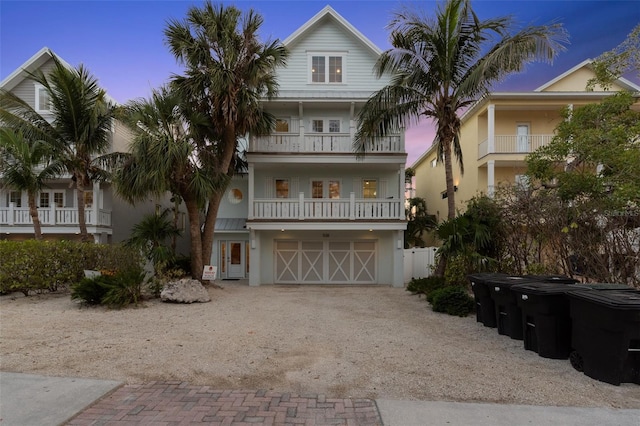 538 Canal Rd, Sarasota, FL 34242 - coastal inspired home with a balcony, driveway, an attached garage, and stucco siding