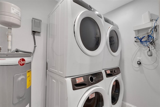 538 Canal Rd, Sarasota, FL 34242 - laundry room featuring stacked washer / dryer and electric water heater