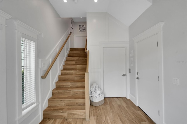 538 Canal Rd, Sarasota, FL 34242 - stairway with wood finished floors, recessed lighting, and a decorative wall