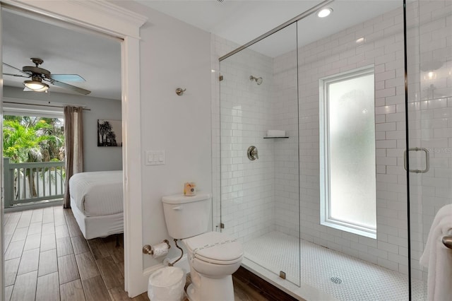 538 Canal Rd, Sarasota, FL 34242 - full bathroom with ensuite bathroom, a stall shower, a ceiling fan, and wood finished floors