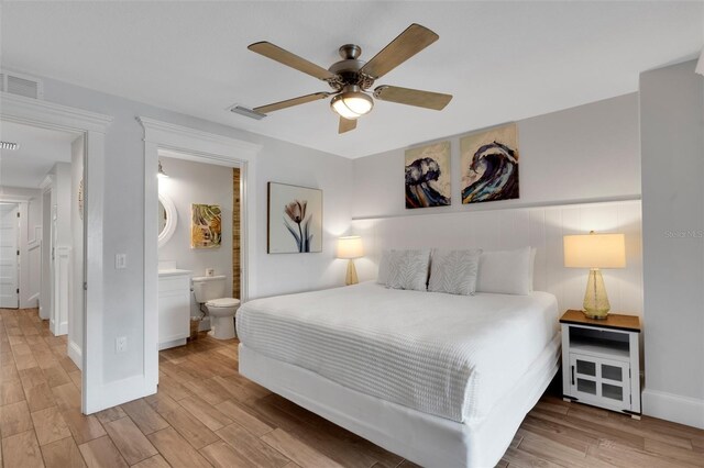 538 Canal Rd, Sarasota, FL 34242 - bedroom featuring wood finished floors, ensuite bath, and a ceiling fan