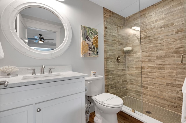 538 Canal Rd, Sarasota, FL 34242 - bathroom with tiled shower, vanity, wood finished floors, and ceiling fan