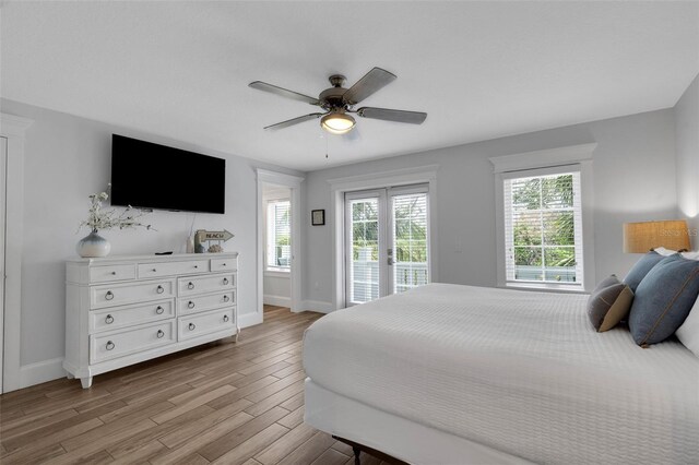 538 Canal Rd, Sarasota, FL 34242 - bedroom featuring access to exterior, multiple windows, and light wood finished floors