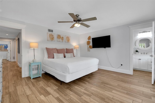 538 Canal Rd, Sarasota, FL 34242 - bedroom with light wood-type flooring, ceiling fan, and ensuite bath