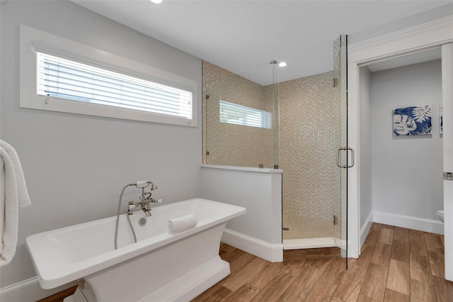538 Canal Rd, Sarasota, FL 34242 - full bathroom featuring a stall shower, a freestanding tub, wood finished floors, and recessed lighting