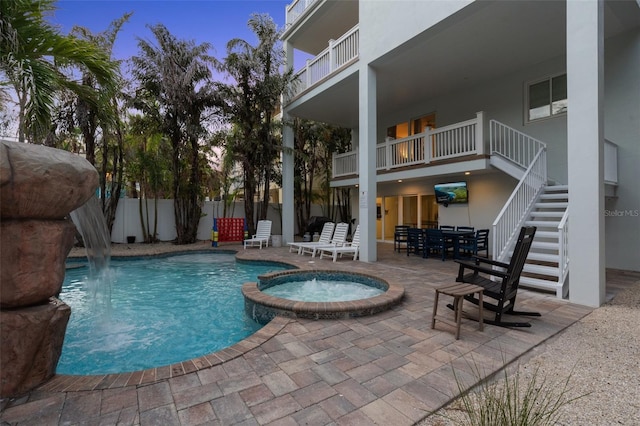 538 Canal Rd, Sarasota, FL 34242 - pool at dusk with stairs, a pool with connected hot tub, and a patio