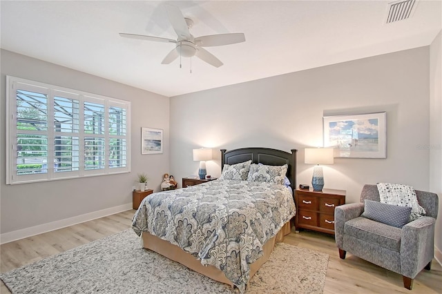 7983 Sandstar Way, Sarasota, FL 34240 - bedroom with light wood-style flooring and ceiling fan