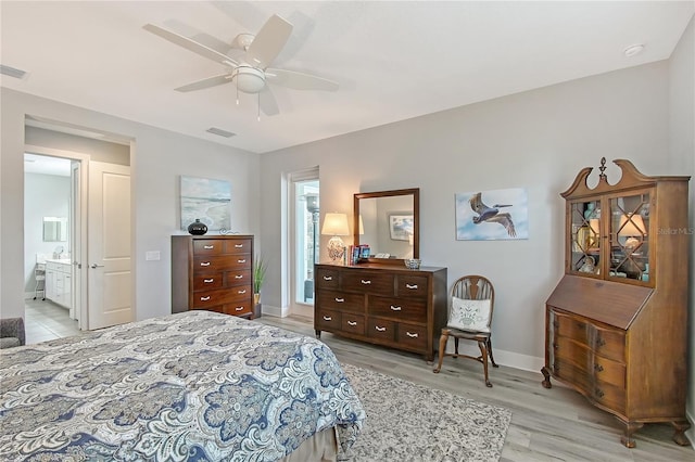 7983 Sandstar Way, Sarasota, FL 34240 - bedroom with light wood-style flooring, a ceiling fan, and ensuite bath