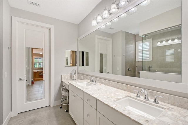 7983 Sandstar Way, Sarasota, FL 34240 - full bath featuring healthy amount of natural light, tile patterned floors, double vanity, and walk in shower