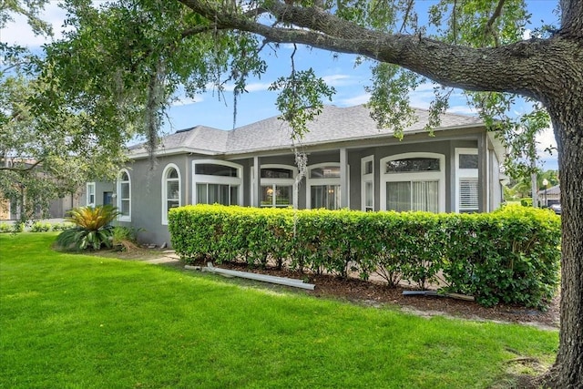 4013 Greystone Dr, Clermont, FL 34711 - rear view of house featuring a lawn and stucco siding