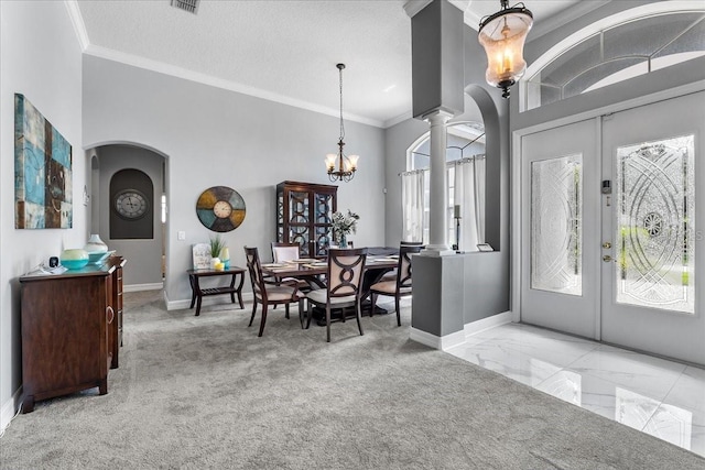 4013 Greystone Dr, Clermont, FL 34711 - foyer featuring arched walkways, french doors, ornate columns, crown molding, and a chandelier