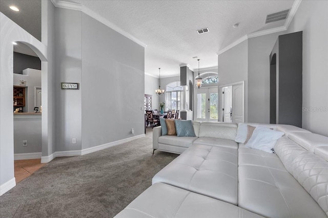 4013 Greystone Dr, Clermont, FL 34711 - living area with carpet flooring, arched walkways, crown molding, a chandelier, and a textured ceiling
