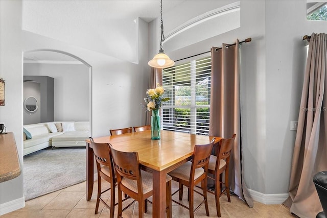 4013 Greystone Dr, Clermont, FL 34711 - dining room with light tile patterned floors, arched walkways, light carpet, and vaulted ceiling