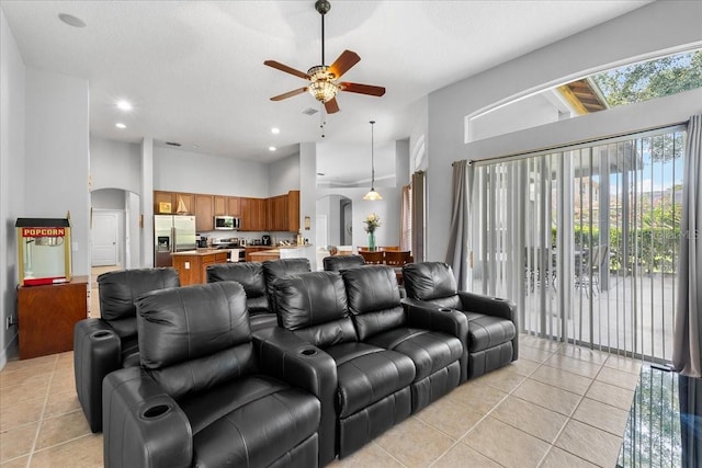 4013 Greystone Dr, Clermont, FL 34711 - living area featuring ceiling fan, light tile patterned flooring, arched walkways, a high ceiling, and recessed lighting