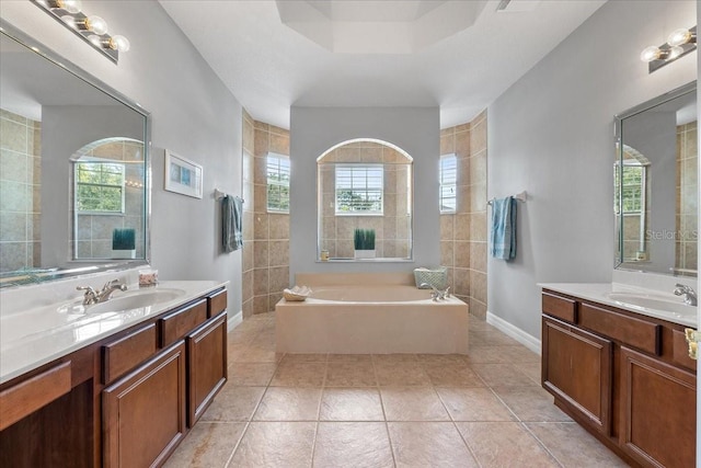 4013 Greystone Dr, Clermont, FL 34711 - full bath with two vanities, a garden tub, and tile patterned flooring