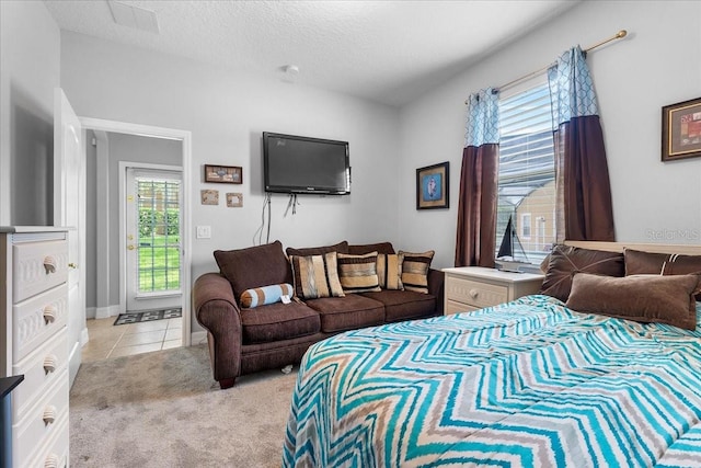 4013 Greystone Dr, Clermont, FL 34711 - bedroom featuring multiple windows, light carpet, a textured ceiling, and light tile patterned floors