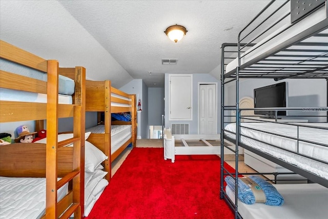 4013 Greystone Dr, Clermont, FL 34711 - bedroom with vaulted ceiling, carpet flooring, and a textured ceiling