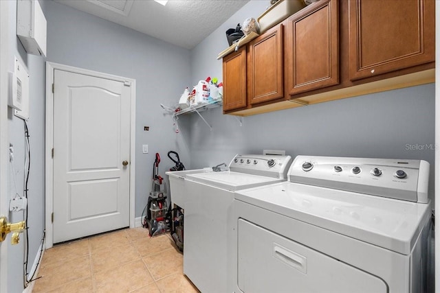 4013 Greystone Dr, Clermont, FL 34711 - laundry room featuring cabinet space, separate washer and dryer, light tile patterned floors, and a textured ceiling