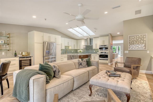 2103 Harbourside Dr Unit 1102, Longboat Key, FL 34228 - living area featuring wine cooler, a ceiling fan, a skylight, recessed lighting, and vaulted ceiling