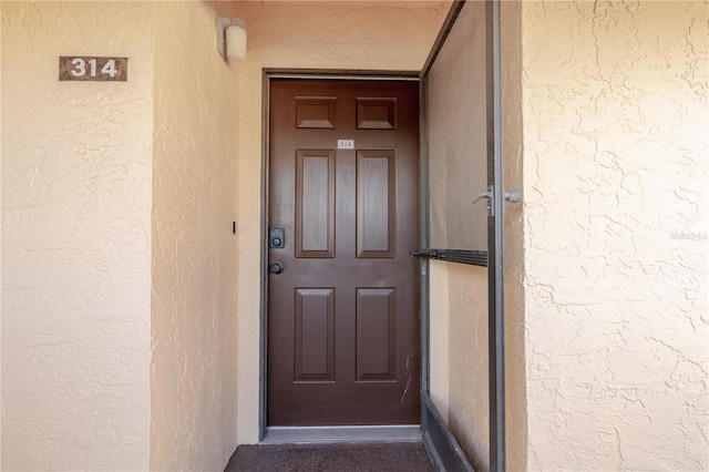 2395 Harbor Blvd Unit 314, Port Charlotte, FL 33952 - doorway to property with stucco siding