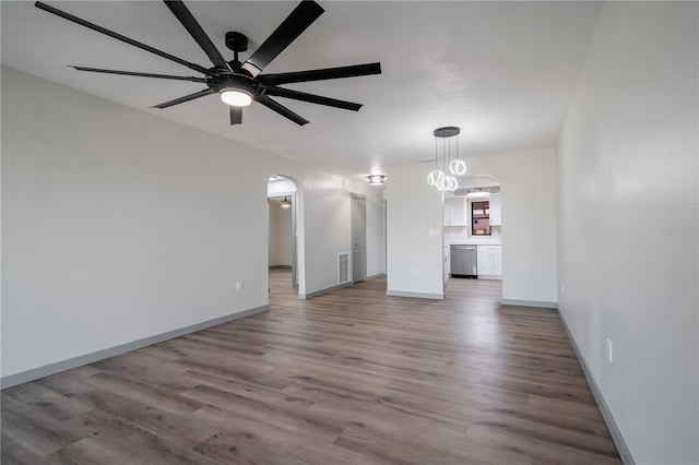 2395 Harbor Blvd Unit 314, Port Charlotte, FL 33952 - unfurnished living room featuring arched walkways, ceiling fan, and wood finished floors